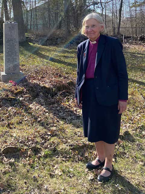 Bishop Victoria Matthews standing in a church yard